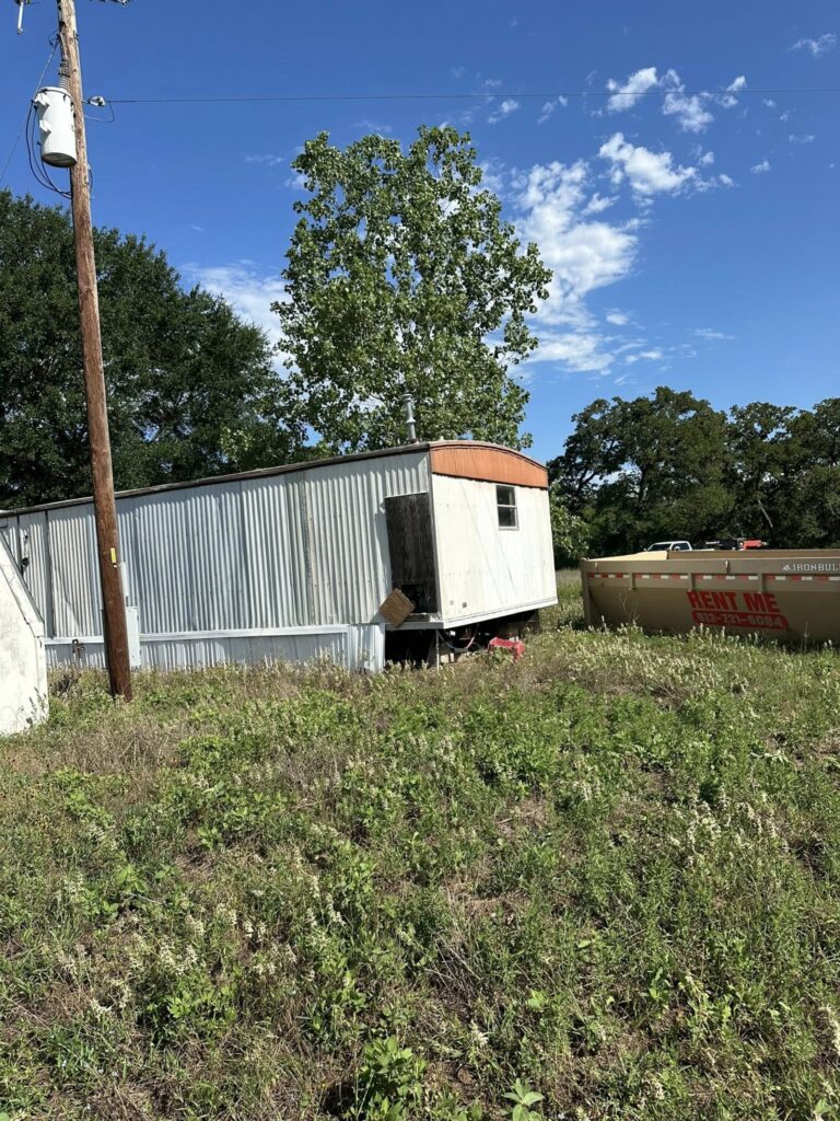 Demolition crew removing rural outbuilding in Texas