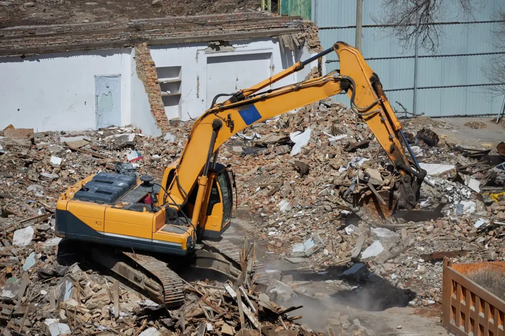 Demolition excavator removing rural outbuilding in Texas