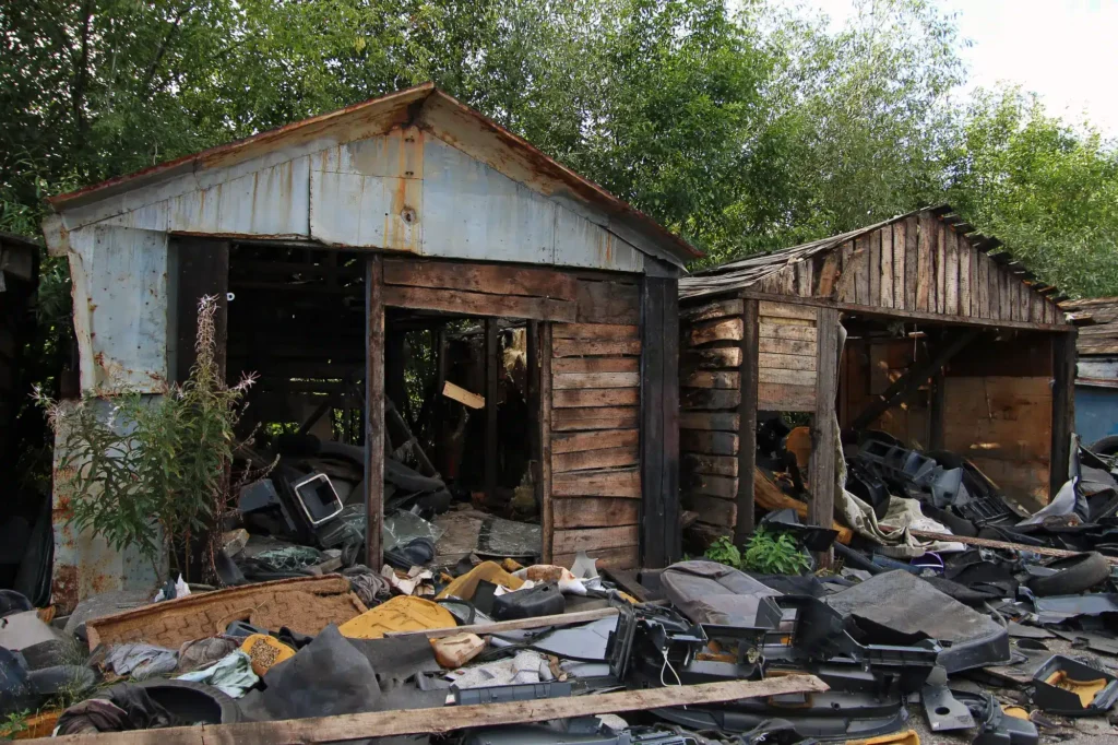 Excavator performing barn demolition on rural Texas property