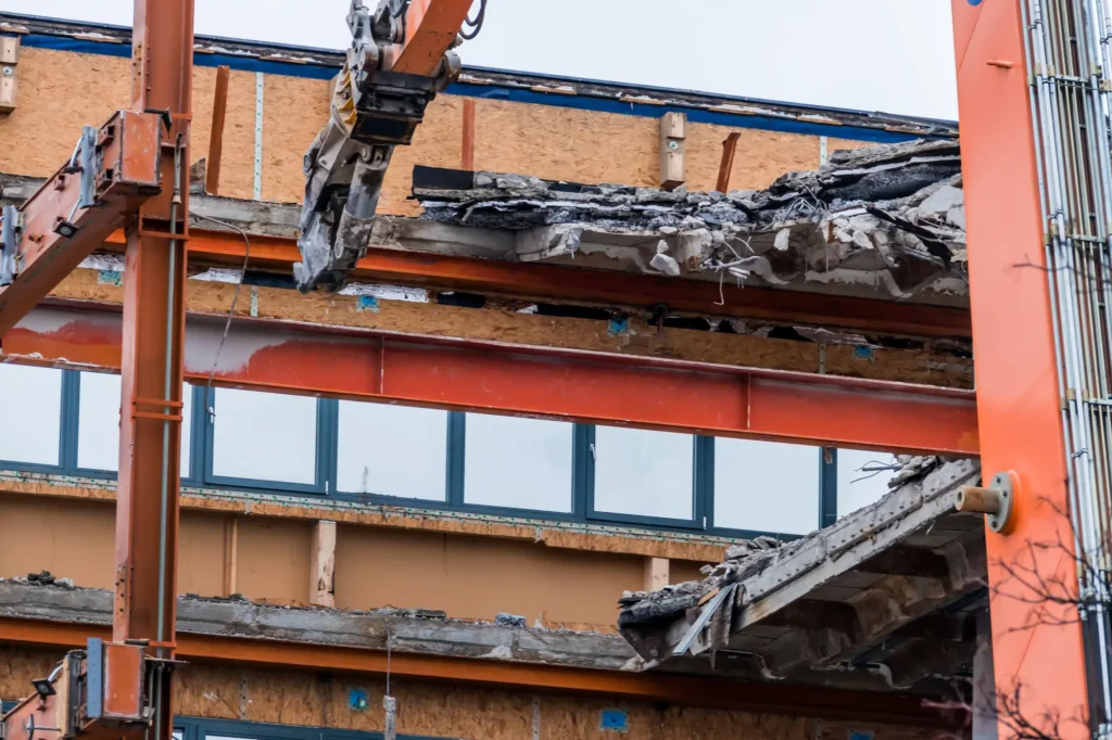 Excavator performing light commercial demolition on Texas property