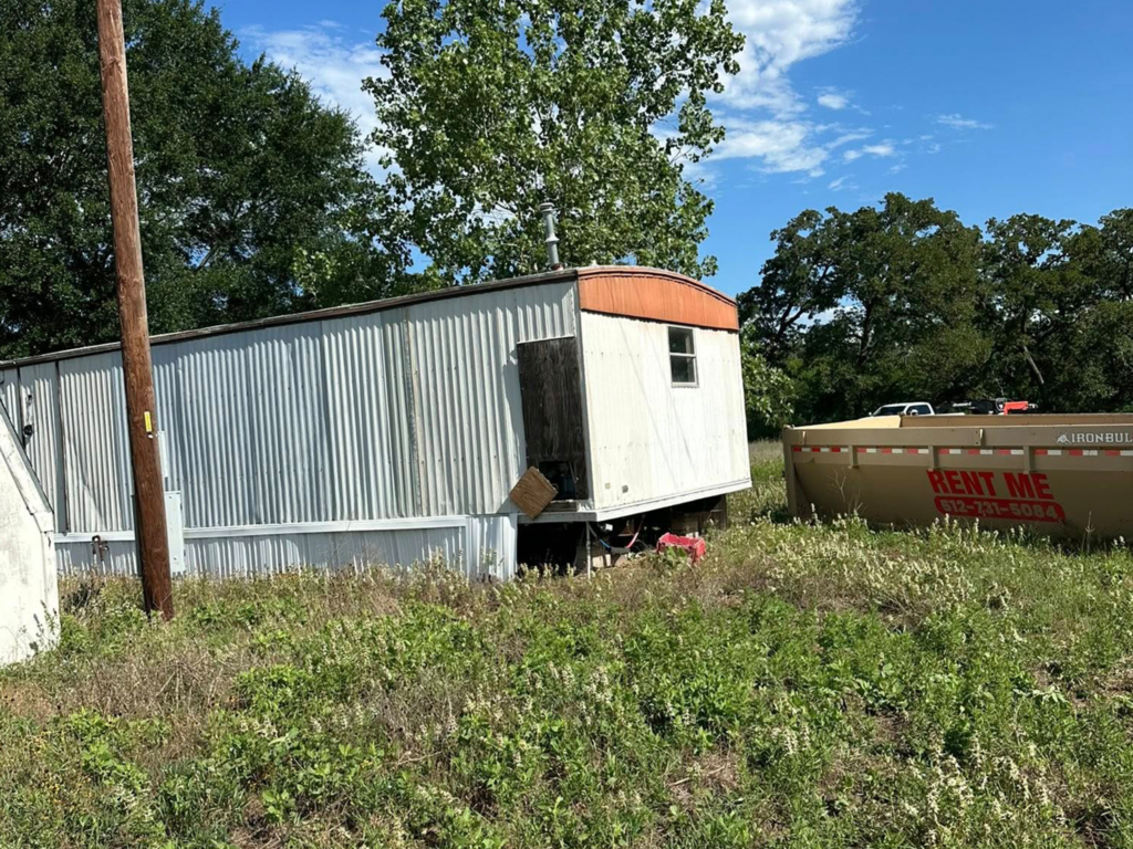 Demolition crew removing rural outbuilding in Texas